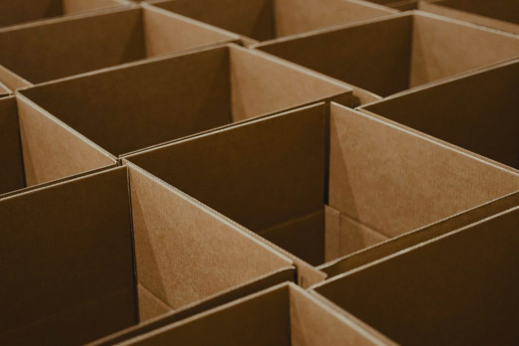 A row of cardboard boxes stacked next to each other. 